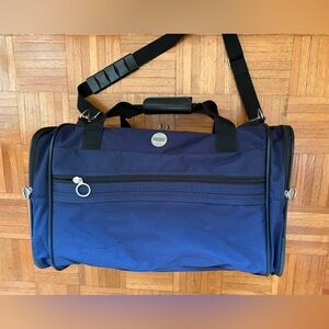 American Tourister Duffel Bag by - Men's Shoulder & Hand Carry.blue